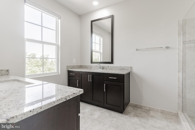 23480 Epperson Sq, Brambleton, VA 20148 - bathroom featuring two vanities, healthy amount of natural light, baseboards, and recessed lighting