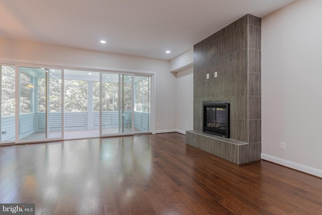 23480 Epperson Sq, Brambleton, VA 20148 - unfurnished living room with dark wood-style flooring, baseboards, a tile fireplace, and recessed lighting