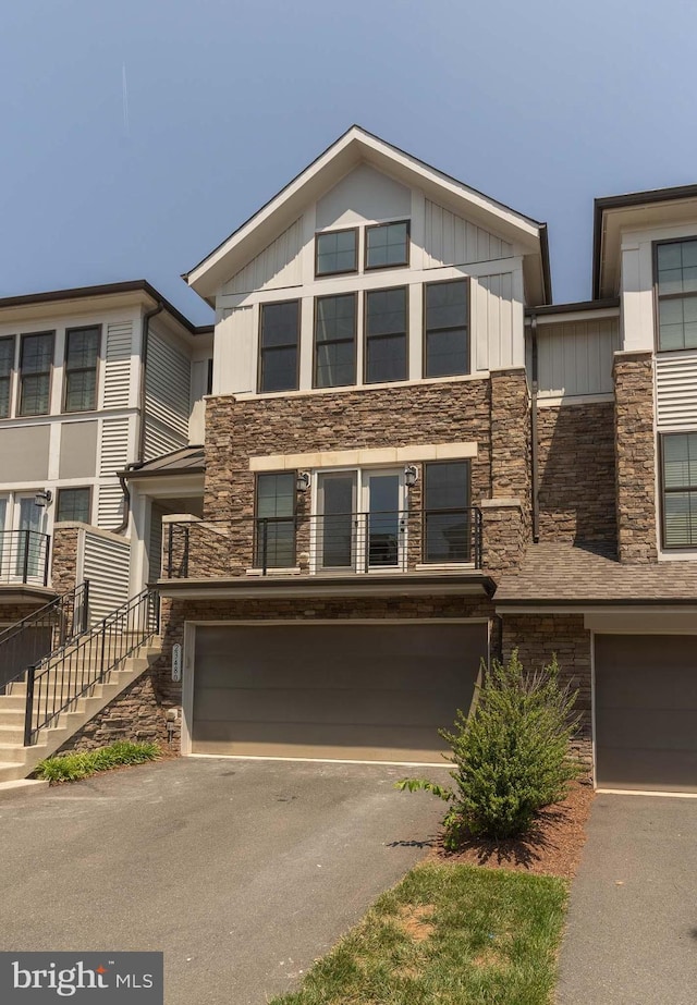23480 Epperson Sq, Brambleton, VA 20148 - view of front facade with a garage, stone siding, asphalt driveway, and stairway