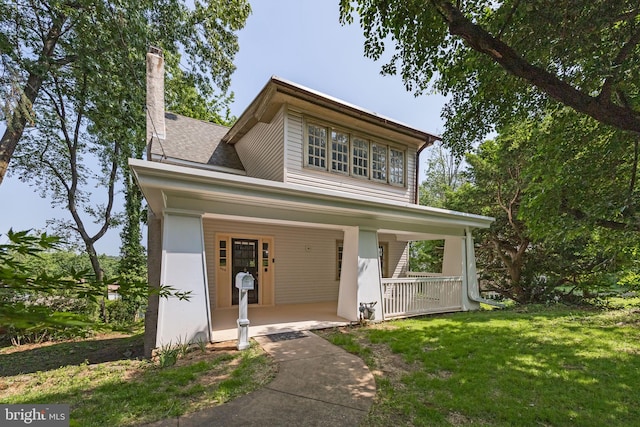 908 Edge Hill Rd, Glenside, PA 19038 - view of front facade with covered porch, a front lawn, and a shingled roof