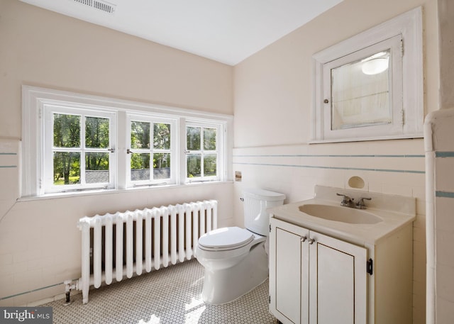 908 Edge Hill Rd, Glenside, PA 19038 - bathroom with radiator heating unit, toilet, vanity, tile walls, and wainscoting