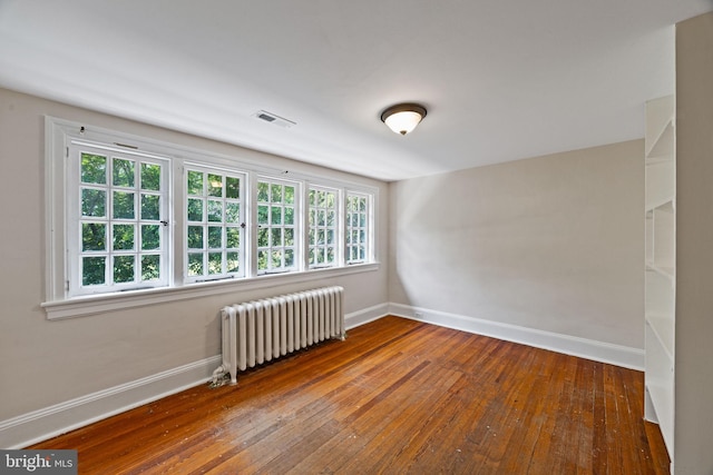 908 Edge Hill Rd, Glenside, PA 19038 - unfurnished room with radiator heating unit, baseboards, wood-type flooring, and plenty of natural light