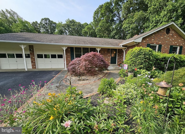 3130 Ashwood Dr, Dunkirk, MD 20754 - view of front of home featuring an attached garage, asphalt driveway, and brick siding