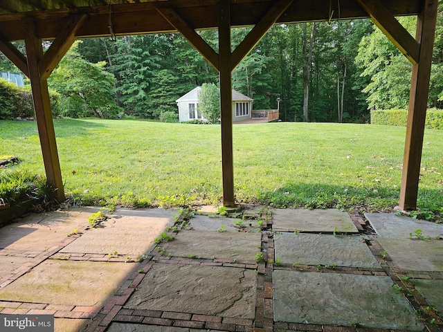 3130 Ashwood Dr, Dunkirk, MD 20754 - view of green lawn featuring a patio area, an outbuilding, and a wooded view