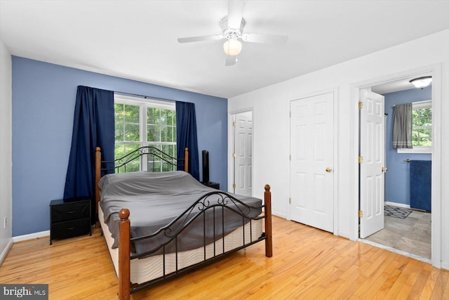 835 Campers Ln, Ruther Glen, VA 22546 - bedroom featuring light wood finished floors, multiple windows, baseboards, and a ceiling fan