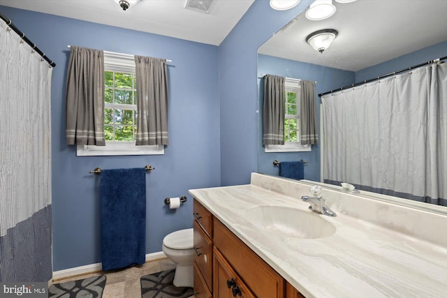 835 Campers Ln, Ruther Glen, VA 22546 - full bathroom with vanity, toilet, baseboards, and curtained shower