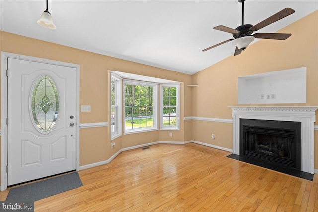 835 Campers Ln, Ruther Glen, VA 22546 - entrance foyer with wood-type flooring, plenty of natural light, baseboards, lofted ceiling, and a fireplace with flush hearth