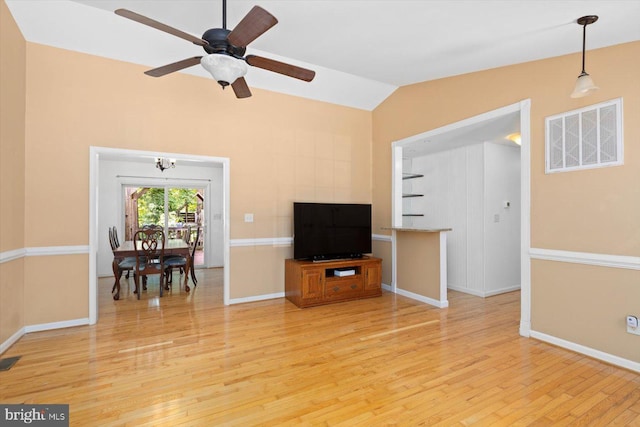 835 Campers Ln, Ruther Glen, VA 22546 - living area featuring light wood-style flooring, lofted ceiling, baseboards, a ceiling fan, and a chandelier