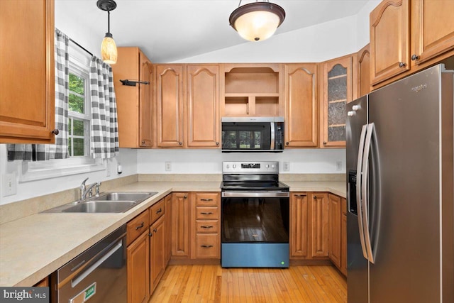 835 Campers Ln, Ruther Glen, VA 22546 - kitchen featuring stainless steel appliances, a sink, lofted ceiling, light wood-type flooring, and light countertops