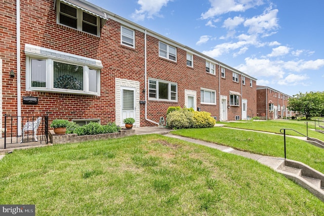 934 Circle Dr, Baltimore, MD 21227 - view of front of house featuring brick siding, a front lawn, and a residential view