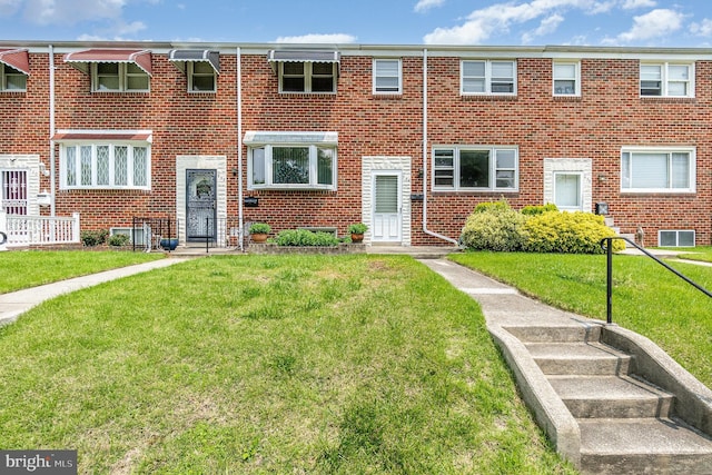 934 Circle Dr, Baltimore, MD 21227 - townhome / multi-family property featuring brick siding and a front yard