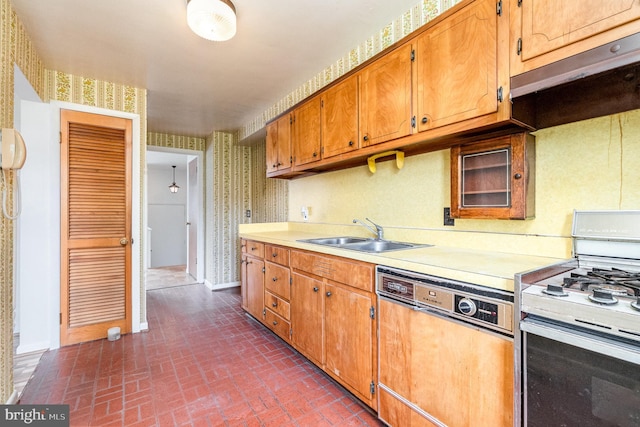 934 Circle Dr, Baltimore, MD 21227 - kitchen with white appliances, a sink, brick patterned floors, light countertops, and wallpapered walls