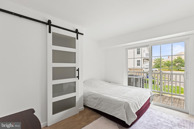 14842 Mason Creek Cir, Woodbridge, VA 22191 - bedroom featuring a barn door, carpet floors, and access to exterior