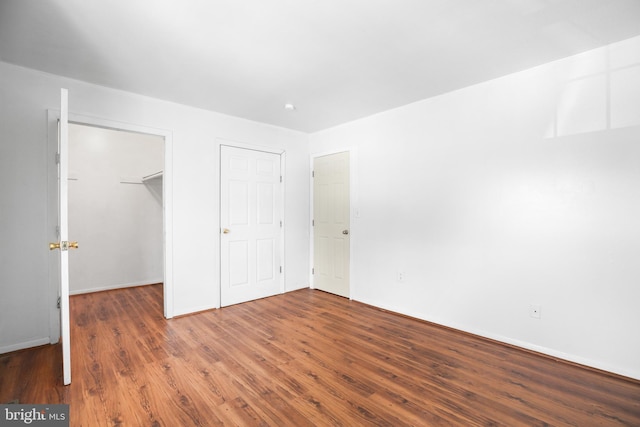 903 Bellows Ave, Fredericksburg, VA 22405 - unfurnished bedroom featuring wood finished floors, a spacious closet, and a closet