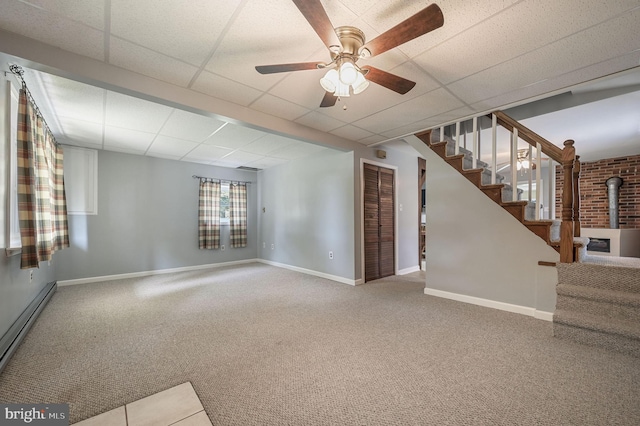 2814 Killens Pond Rd, Harrington, DE 19952 - unfurnished living room with carpet flooring, baseboards, ceiling fan, a drop ceiling, and a baseboard radiator