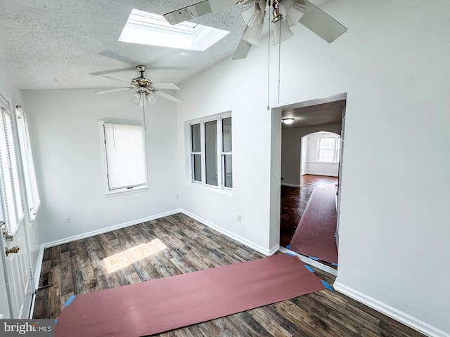 2714 N Pine St, Wilmington, DE 19802 - spare room featuring a ceiling fan, lofted ceiling, a skylight, wood finished floors, and baseboards