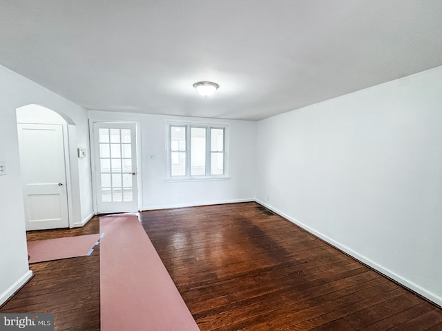 2714 N Pine St, Wilmington, DE 19802 - spare room featuring dark wood-type flooring, arched walkways, and baseboards
