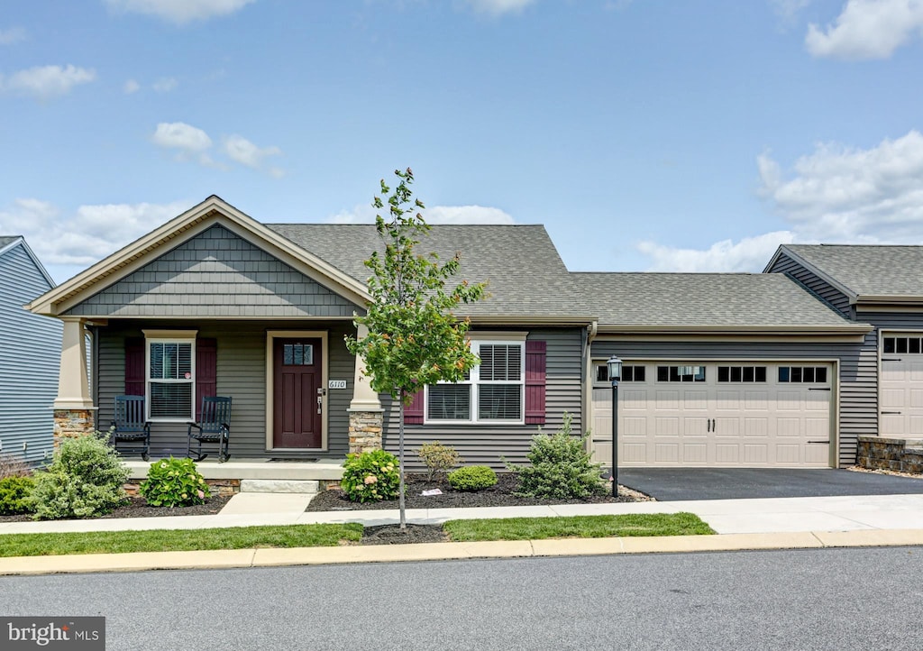 6110 Weston Dr, Harrisburg, PA 17111 - view of front facade featuring a porch, an attached garage, driveway, and a shingled roof