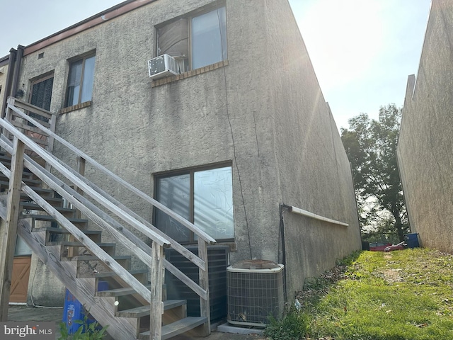 7525 Calvert St, Philadelphia, PA 19152 - back of property with stairway, central air condition unit, stucco siding, and cooling unit