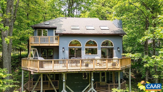 32 Stony Cove Ln, Wintergreen Resort, VA 22967 - back of house with a wooden deck, a shingled roof, and a chimney