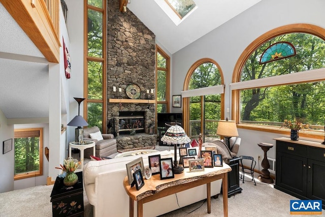 32 Stony Cove Ln, Wintergreen Resort, VA 22967 - living area with high vaulted ceiling, light carpet, a skylight, and a stone fireplace