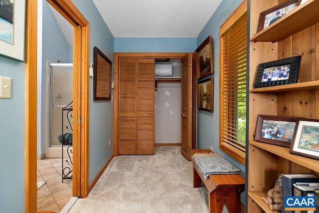 32 Stony Cove Ln, Wintergreen Resort, VA 22967 - hall with baseboards, a textured ceiling, a wall unit AC, and tile patterned floors