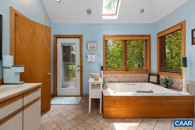 32 Stony Cove Ln, Wintergreen Resort, VA 22967 - full bathroom with lofted ceiling, a skylight, a garden tub, vanity, and tile patterned floors