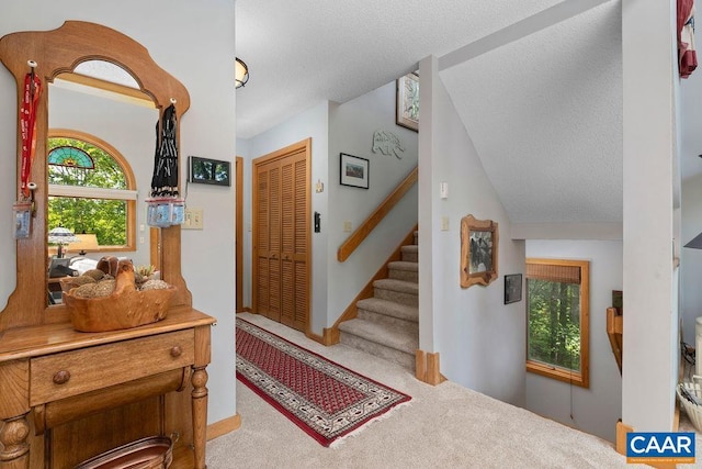 32 Stony Cove Ln, Wintergreen Resort, VA 22967 - entrance foyer featuring stairway, carpet flooring, and a textured ceiling