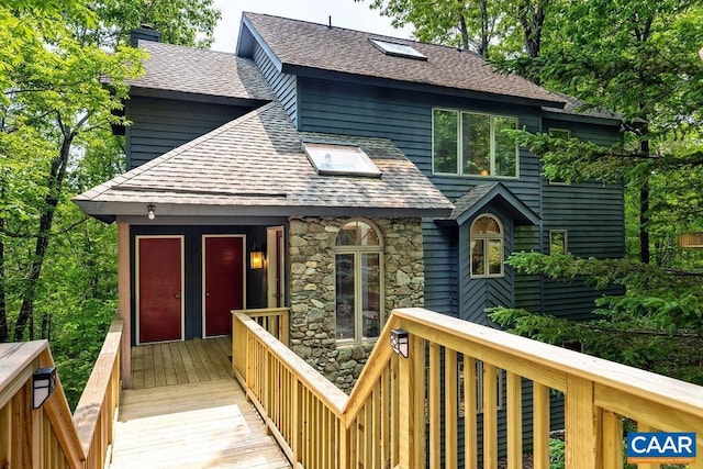 32 Stony Cove Ln, Wintergreen Resort, VA 22967 - back of house featuring a shingled roof, a chimney, and stone siding