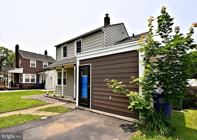 816 Margaret St, Reading, PA 19611 - view of front of house with a chimney and a front lawn