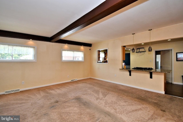 816 Margaret St, Reading, PA 19611 - unfurnished living room with carpet, baseboards, beam ceiling, and healthy amount of natural light