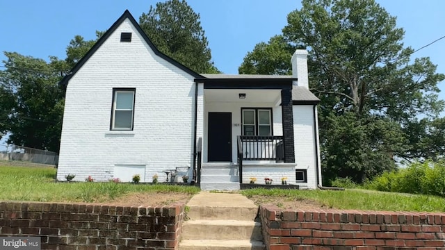 505 62nd Ave, Capitol Heights, MD 20743 - view of front of house featuring brick siding, a chimney, and a porch