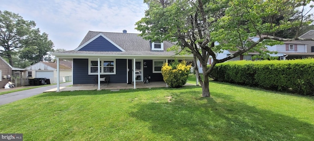 424 Exton Rd, Hatboro, PA 19040 - view of front of property featuring a front yard, an outdoor structure, a shingled roof, and covered porch