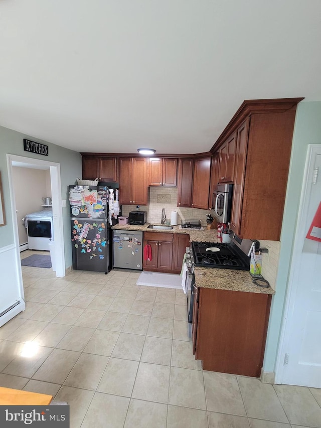 424 Exton Rd, Hatboro, PA 19040 - kitchen featuring stainless steel appliances, tasteful backsplash, light tile patterned floors, a sink, and light stone countertops