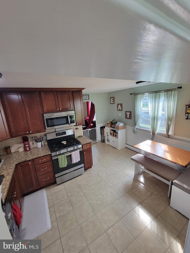 424 Exton Rd, Hatboro, PA 19040 - kitchen featuring appliances with stainless steel finishes, light stone counters, light tile patterned floors, and a baseboard radiator
