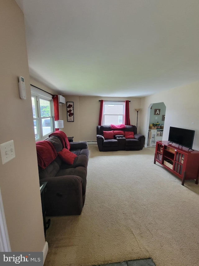 424 Exton Rd, Hatboro, PA 19040 - carpeted living room featuring an AC wall unit and arched walkways