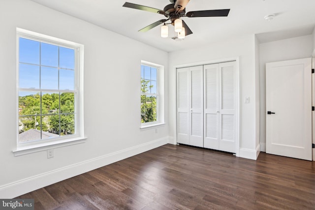 322 56th St NE, Washington, DC 20019 - unfurnished bedroom with baseboards, dark wood-style floors, a closet, and ceiling fan