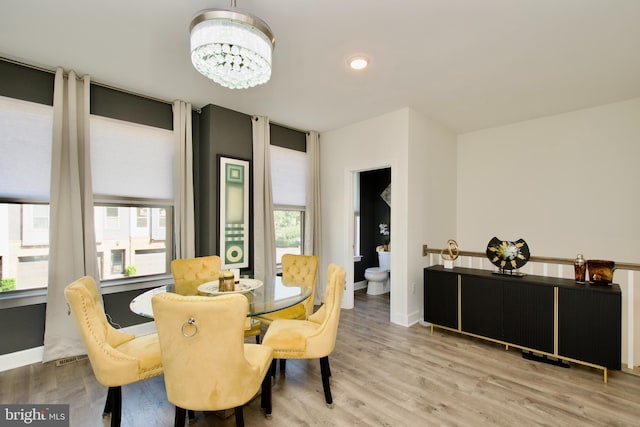 45401 Daveno Sq, Sterling, VA 20164 - dining room with light wood-style flooring, a chandelier, and baseboards