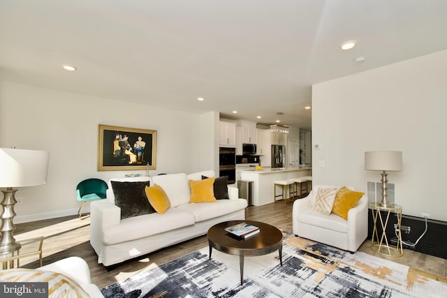 45401 Daveno Sq, Sterling, VA 20164 - living area featuring light wood-style flooring, recessed lighting, and baseboards