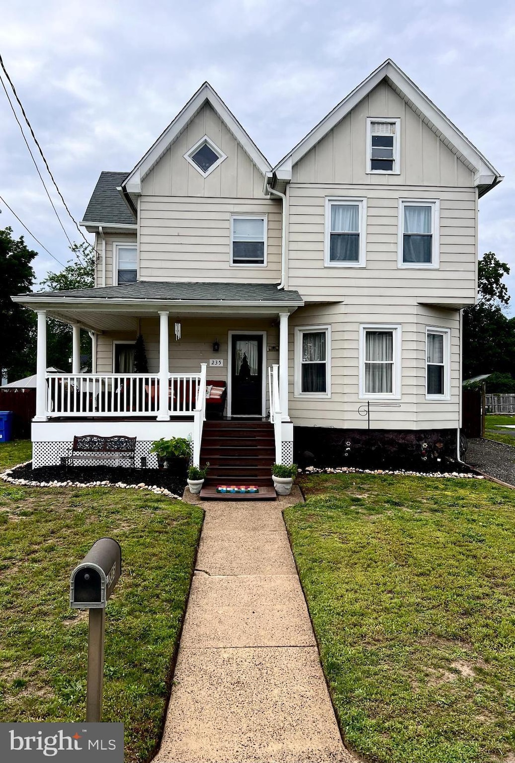 235 W High St, Clayton, NJ 08312 - view of front of property with board and batten siding, a front yard, and covered porch