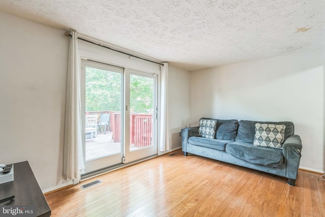 5959 Rowanberry Dr Unit 8E, Elkridge, MD 21075 - living room with hardwood / wood-style floors, a textured ceiling, and baseboards
