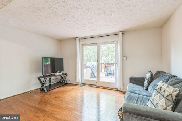 5959 Rowanberry Dr Unit 8E, Elkridge, MD 21075 - living area featuring wood finished floors, a textured ceiling, and baseboards