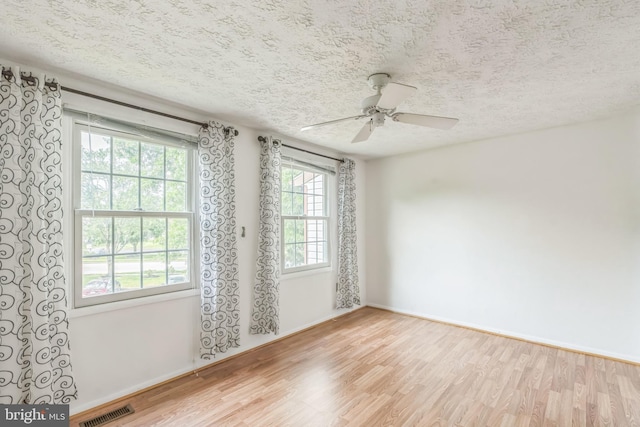 5959 Rowanberry Dr Unit 8E, Elkridge, MD 21075 - empty room with wood finished floors, a textured ceiling, a ceiling fan, and baseboards