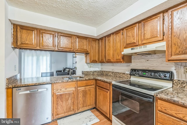 5959 Rowanberry Dr Unit 8E, Elkridge, MD 21075 - kitchen featuring range with electric stovetop, stainless steel dishwasher, under cabinet range hood, a sink, and brown cabinetry