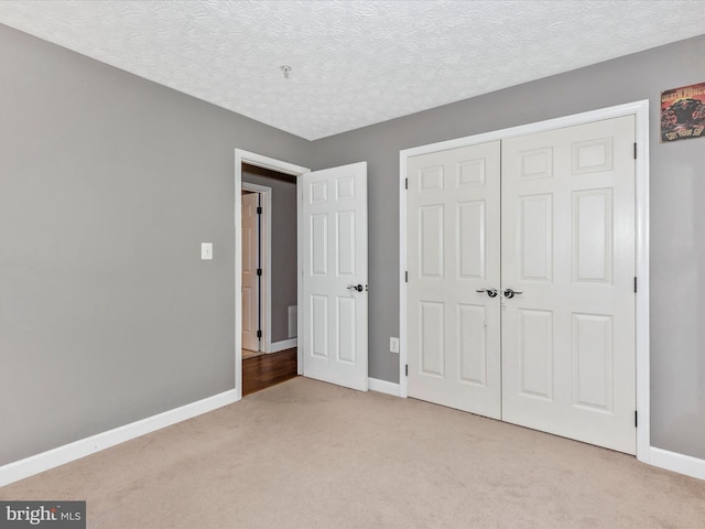 6505 Springwater Ct Unit 7103, Frederick, MD 21701 - unfurnished bedroom with light carpet, baseboards, a closet, and a textured ceiling