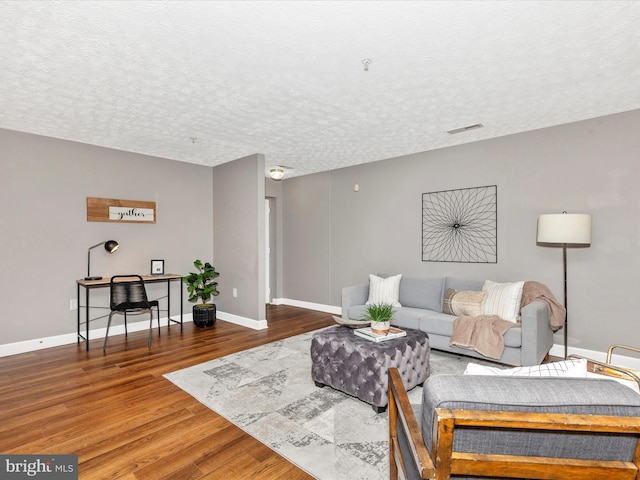 6505 Springwater Ct Unit 7103, Frederick, MD 21701 - living room featuring wood finished floors, baseboards, and a textured ceiling