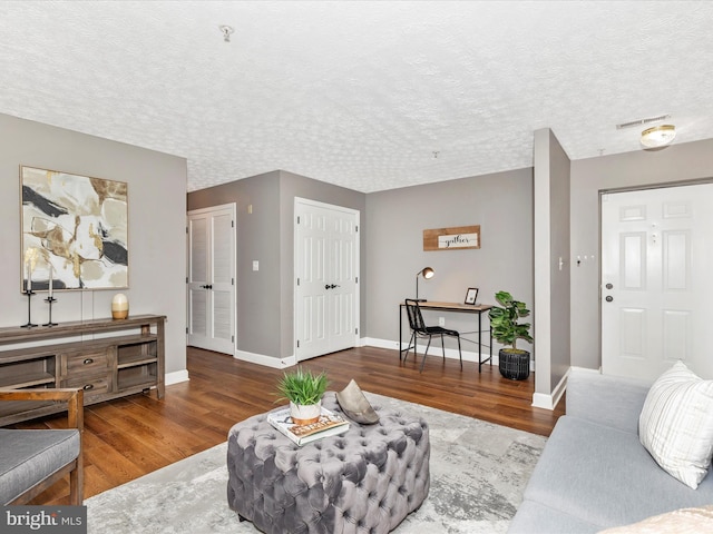 6505 Springwater Ct Unit 7103, Frederick, MD 21701 - living area with wood finished floors, baseboards, and a textured ceiling