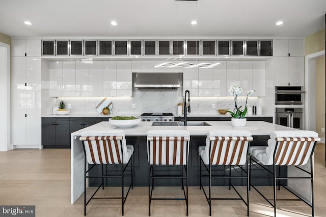 1573 Westmoreland St, Mclean, VA 22101 - kitchen featuring modern cabinets, a sink, exhaust hood, tasteful backsplash, and recessed lighting