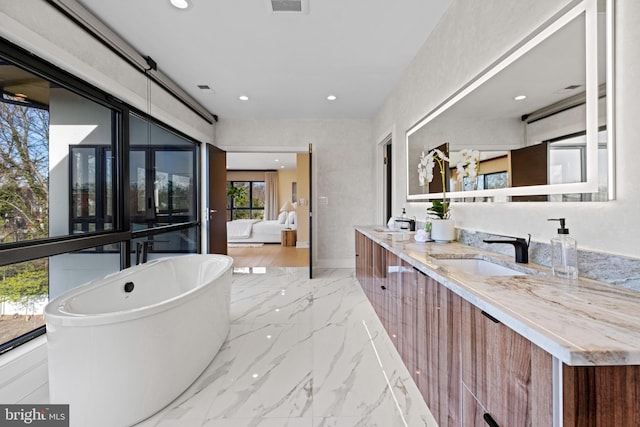 1573 Westmoreland St, Mclean, VA 22101 - ensuite bathroom with marble tiled floors, double vanity, a freestanding tub, and recessed lighting