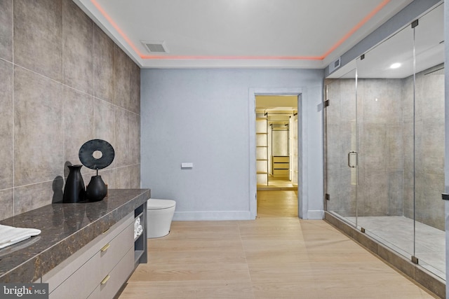 1573 Westmoreland St, Mclean, VA 22101 - full bath featuring a stall shower, vanity, toilet, wood finished floors, and baseboards